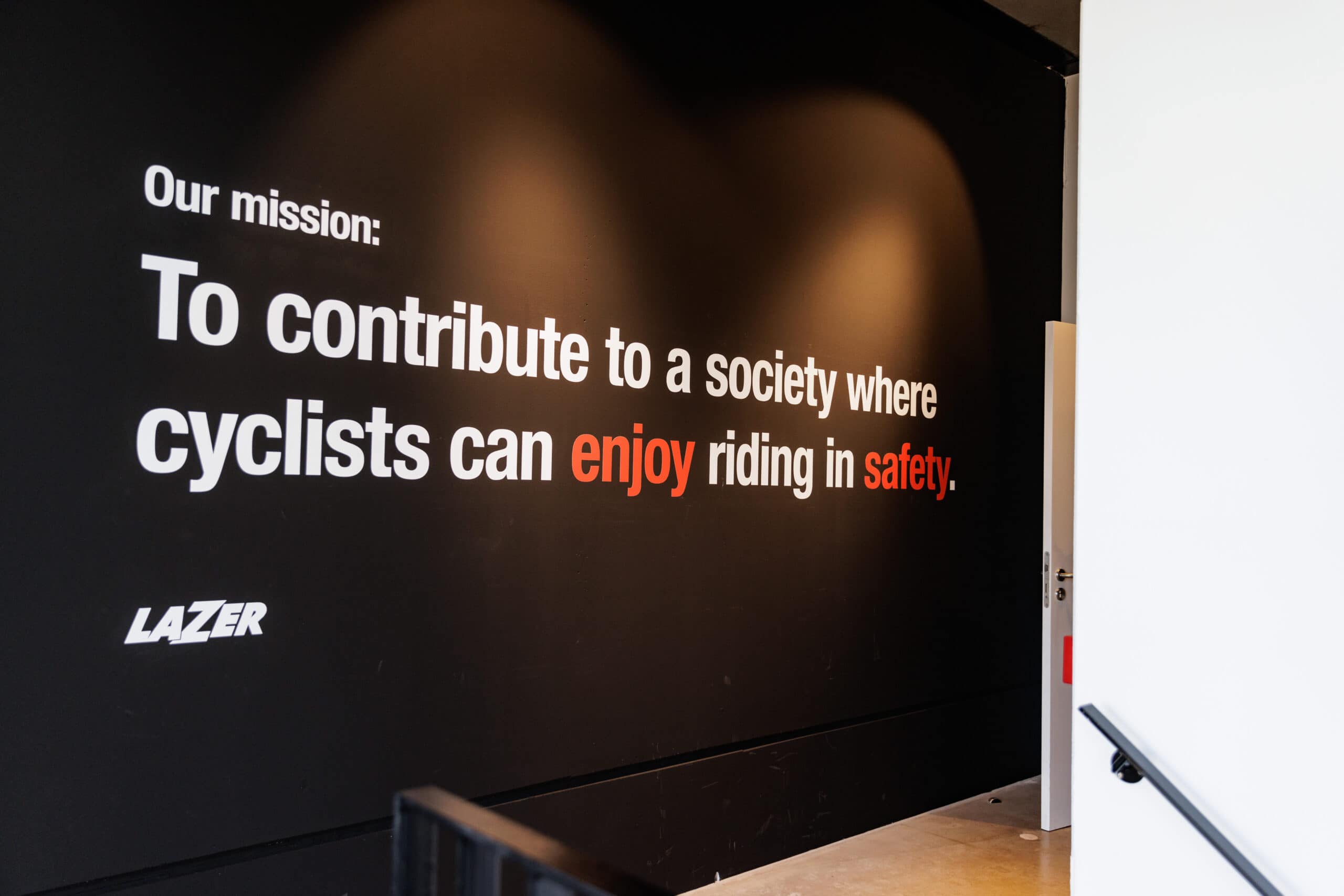 Lazer Brand Development mission statement emphasizing safety and enjoyment for cyclists in a modern workspace. - Alexi Hall