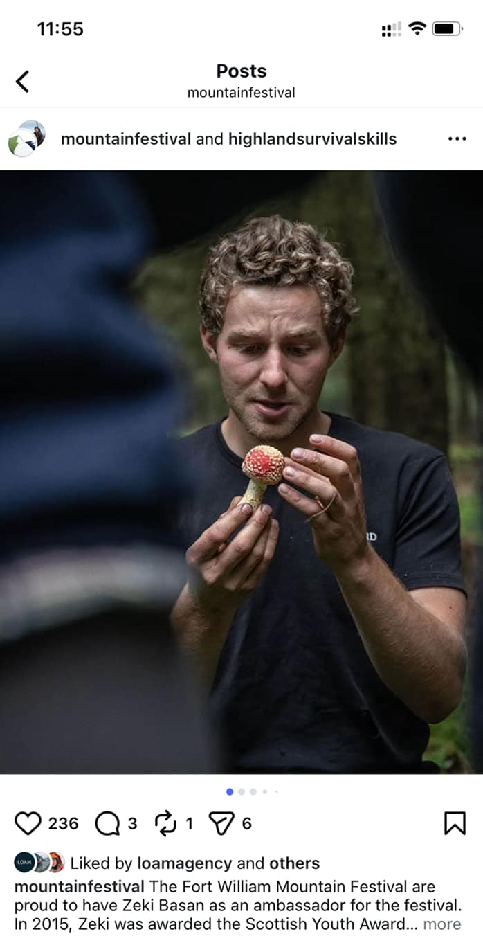 A participant at the Mountain Festival examines a mushroom, showcasing outdoor skills and nature appreciation. - Alexi Hall